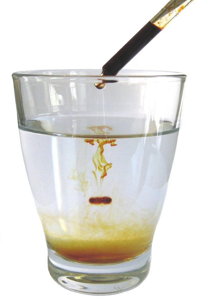 Lugolsche Lösung Glas Wasser, in das eine braune Flüssiglkkeit getropft wird